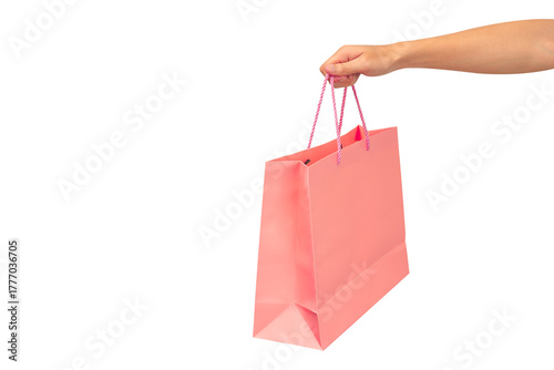 Hand holding pink shopping bag isolated on transparent background