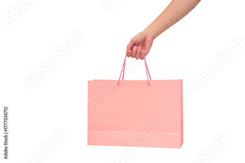 Hand holding pink shopping bag isolated on transparent background