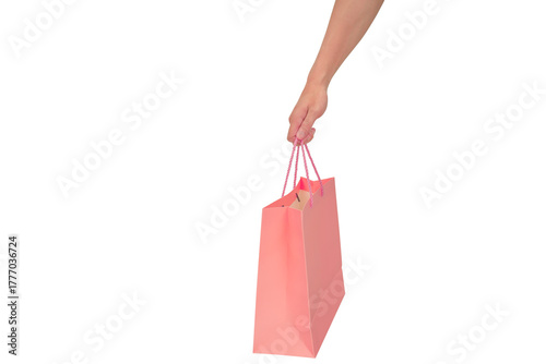 Hand holding pink shopping bag isolated on transparent background