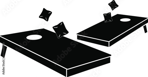 Black and white silhouette illustration of cornhole boards with bean bags flying through the air during a backyard game