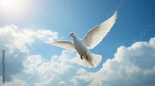 White dove flying gracefully through a bright blue sky with clouds