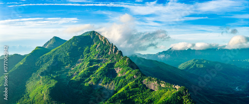 Panoramic view of the majestic green mountain range and forest natural landscape in the morning