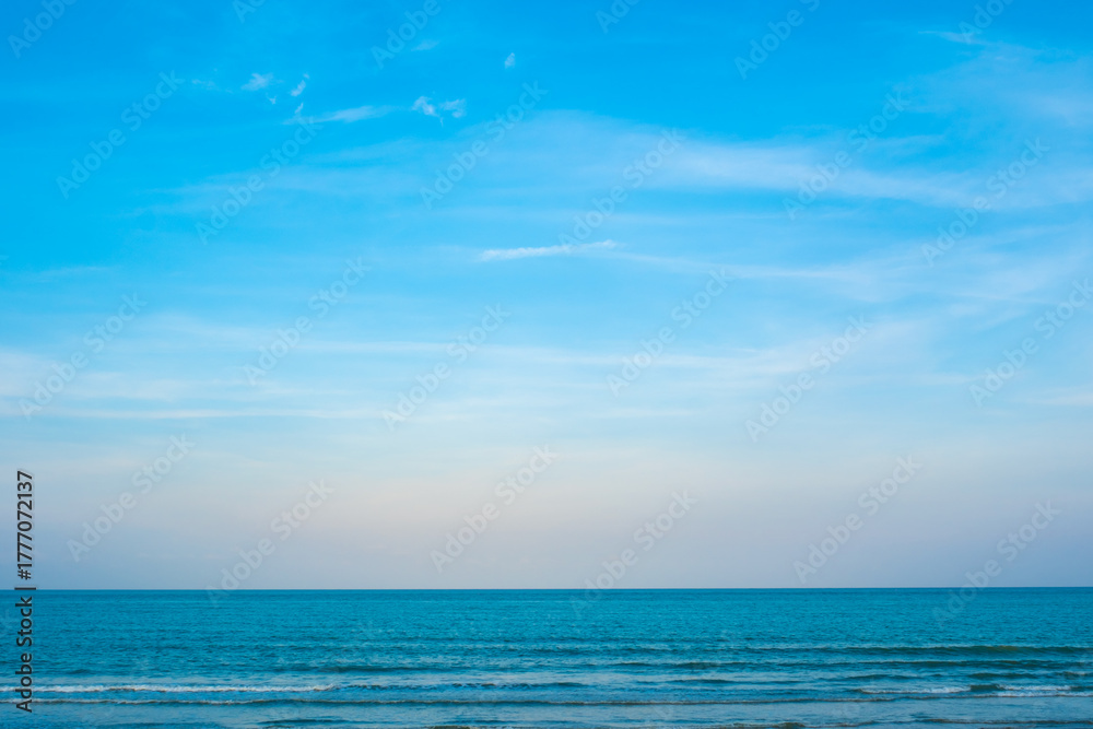 Fototapeta premium Nature of the ocean and blue sky Summer with sunshine, sandy beaches, clear blue waters sparkling against the blue sky. on an island with good ecology and environment Background for summer vacation