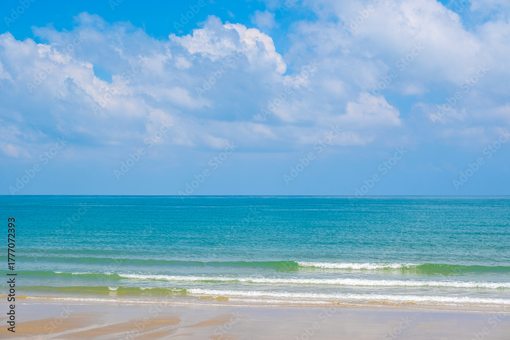 Fototapeta premium Nature of the ocean and blue sky Summer with sunshine, sandy beaches, clear blue waters sparkling against the blue sky. on an island with good ecology and environment Background for summer vacation