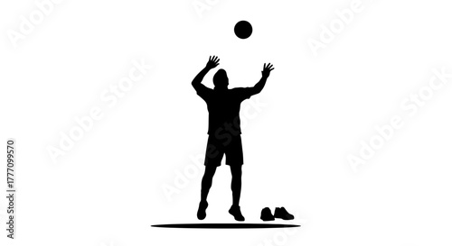 Dynamic silhouette captures the thrilling moment of a volleyball player leaping to serve the ball with energetic focus and athletic prowess
