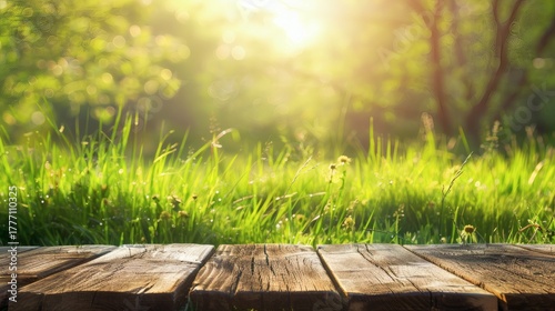 Fototapeta Naklejka Na Ścianę i Meble -  Sunny summer day in a lush green meadow with wooden planks in the foreground