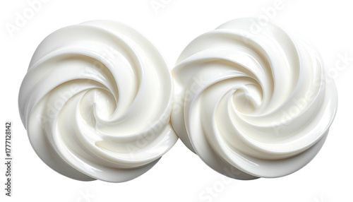Two swirls of white cream against a black background
