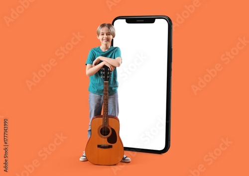 Big smartphone and little boy with guitar on orange background