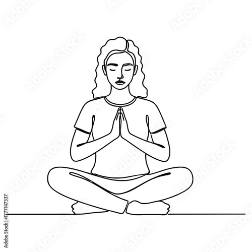 Woman meditating in lotus position with hands pressed together