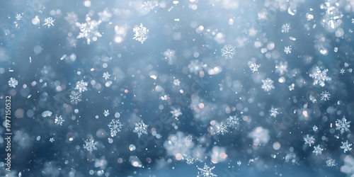 Falling snowflakes on soft blue background