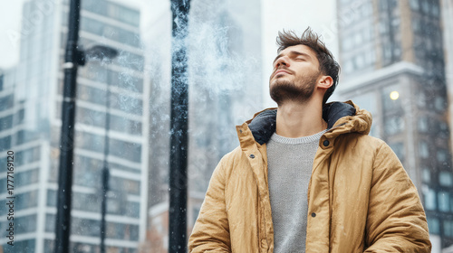 Wallpaper Mural Man stands peacefully near streetlamp, enjoying moment of calm while smoking. urban backdrop Torontodigital.ca