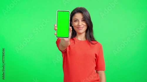 Smiling woman showing a green screen smartphone