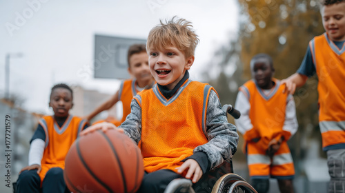 Young boy in wheelchair playing basketball with friends outdoors, wearing orange jerseys, smiling and enjoying game. Inclusive sports activity promoting teamwork and joy