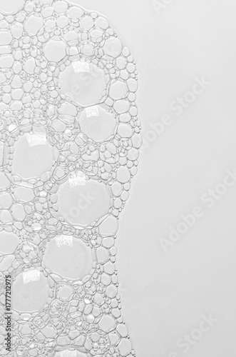 The texture of the foam of shower gel or soap suds or shaving foam. Macrophotography. Copy space