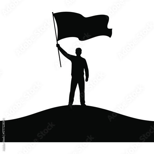 Silhouette of a person holding a flag atop a hill