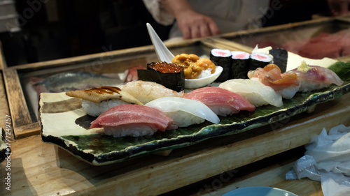 Photos sushi in omakase on sushi bar in Japanese restaurant at Tokyo,  in Fish Market,