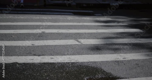 Feet and bike moving across cross walk - low, closeup shot
