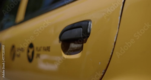 Closeup on hand opening and closing Taxi door in New York city