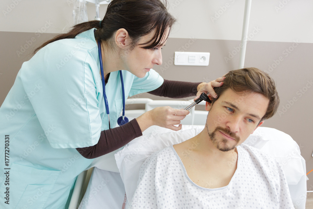 Fototapeta premium female doctor checks the ear