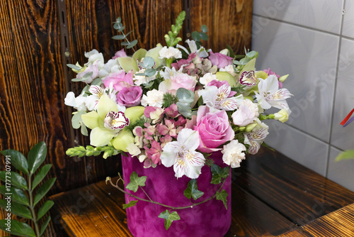 Luxury floral arrangement: pink roses, orchids, hydrangea in velvet box bouquet