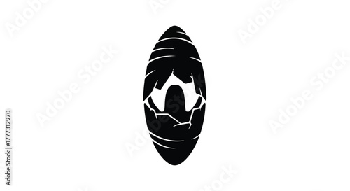 Abstract dark silhouette of a cocoons opening with a mysterious glow from within.