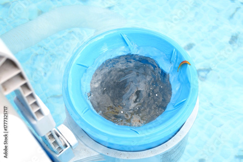 Top view of the blue skimmer for cleaning the pool in clear water. Contaminated pool cleaning concept