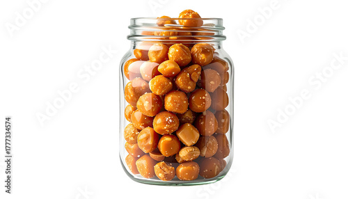 Jar brimming with glazed nuts, golden hue, against dark background