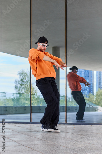 European stylish young choreographer conducts a dance class on the street