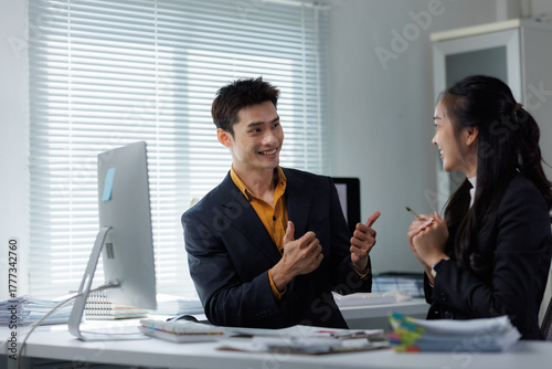 Business people celebrating success with thumbs up