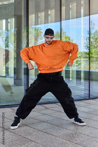 European stylish young choreographer man doing warm-up before performance