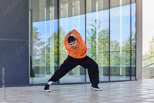 Stylish hipster man in cool clothes makes dance moves