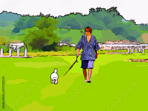 公園を散歩するビションフリーゼと男性