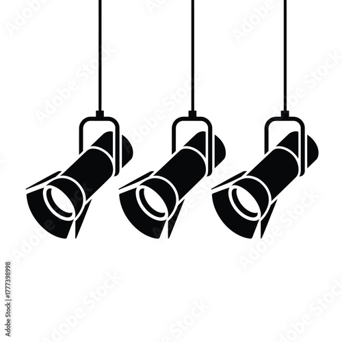 Three black spotlights hanging from ceiling in a row