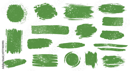 A collection of green grungetextured brush strokes and circular shapes on a white background