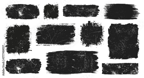 A collection of eleven grungy irregularly shaped black textures with white scratches displayed on a plain white background