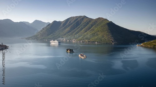 Timelapse drone shot of cruise ship arriving to The bay of Kotor in Montenegro, soft sunlight in the bay. Perast and Islands on a foreground.