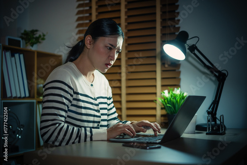 stressed woman working with laptop at night