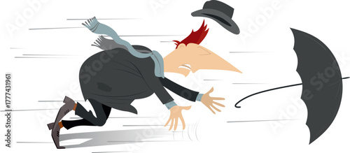 Stormy weather. Man loses an umbrella and a hat on the strong wind