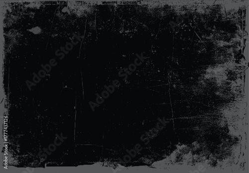 Dark textured background with distressed grunge effect and subtle scratches and speckles black gray