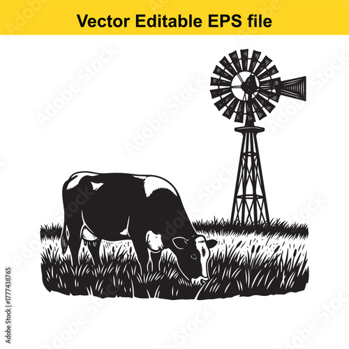 Cow grazing in a field with a windmill in the background