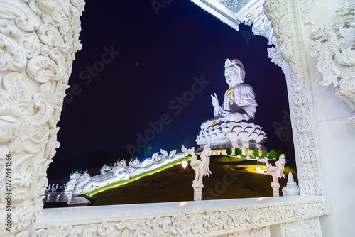 Guan Yin Statue through window of Ubosot, Wat Huai Pla Kang, Chiang Rai, Thailand