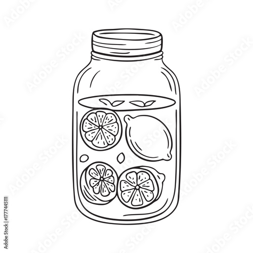 Glass jar tightly packed with preserved lemons soaking in brine