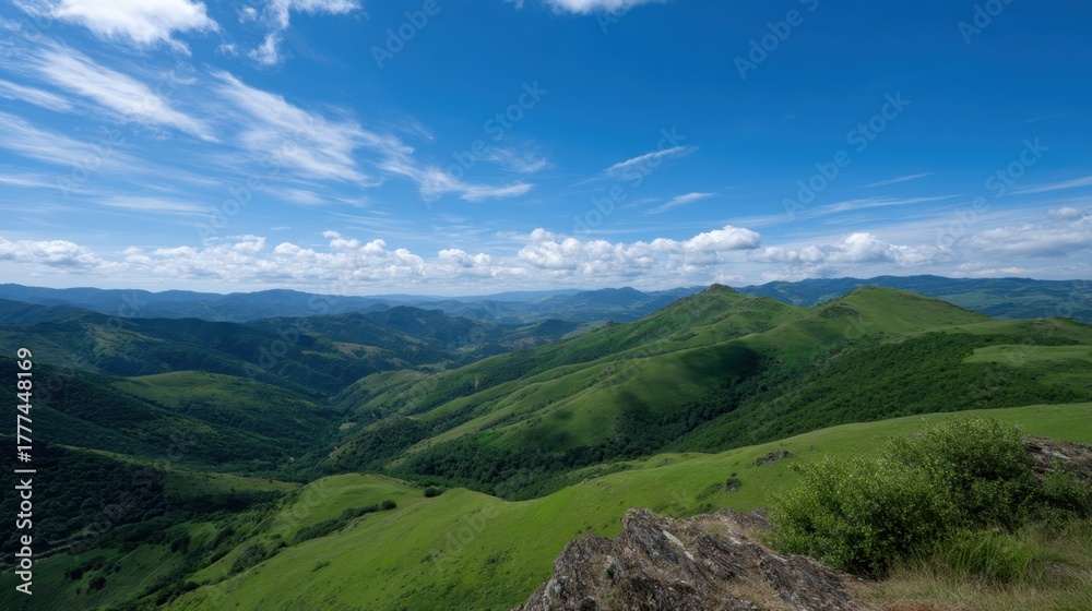 Naklejka premium Sunlit Panoramic Ridge View Overlooking Lush Green Hills and Vast Blue Sky