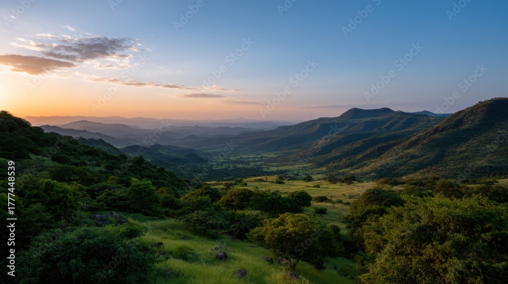 Fototapeta premium Stunning Sunset Over Green Hills in Panoramic View with Soft Colors and Serene Beauty