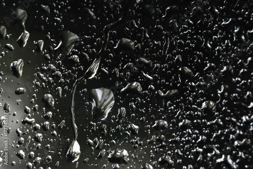 Foto Moody close up of wet glass surface with water droplet and rain texture