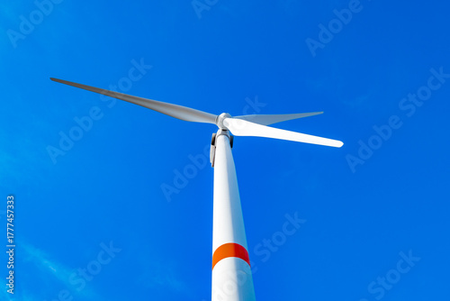 electric wind turbine on background of sky, bottom view