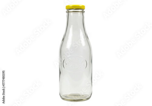 Isolated vintage style clear glass milk bottle with a yellow cap on a neutral background
