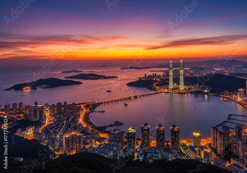 Dalian, China cityscape view at sunset featuring bridges, ocean, and illuminated buildings