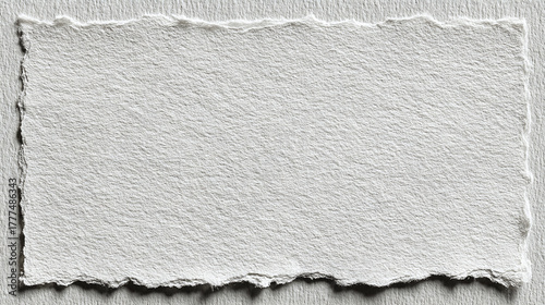 A textured piece of paper with a torn edge, creating a simple and elegant design