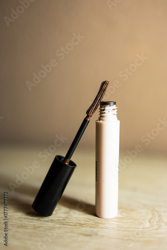 Brown mascara bottle with unique brush for eye makeup.

